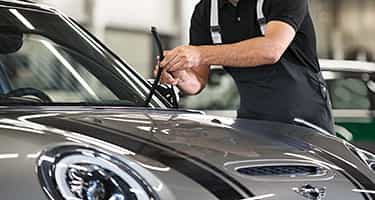 Certified MINI Technician performs routine vehicle maintenance